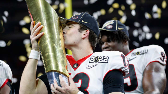 Georgia quarterback Stetson Bennett (13) kisses the trophy after winning the College Football Playoff National Championship on Jan. 10 at Lucas Oil Stadium in Indianapolis.